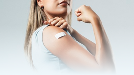 Nainen, jolla on laastari olkapäässä influenssarokotuksen jälkeen.